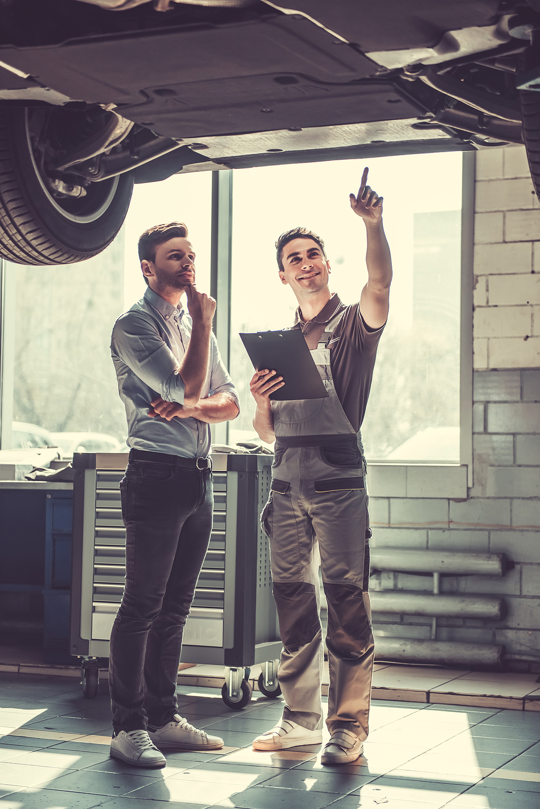 Two Auto Repair Technicians fill out the Bid Sheet Form for Parts and Labor on Automotive Shop Repair Order